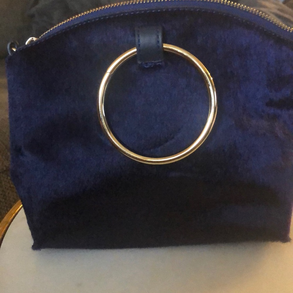Navy blue faux fur clutch wristlet bag.